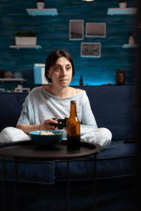 sad woman playing games and drinking