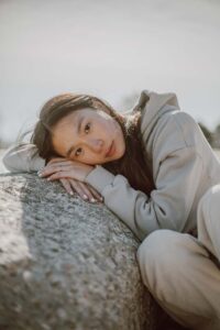 teen girl leaning on rock